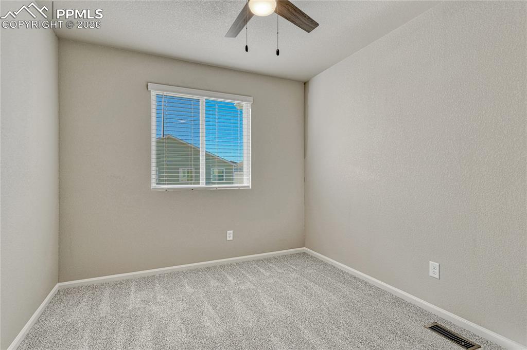Image 23 of 29: Second of two additional upstairs bedrooms. 