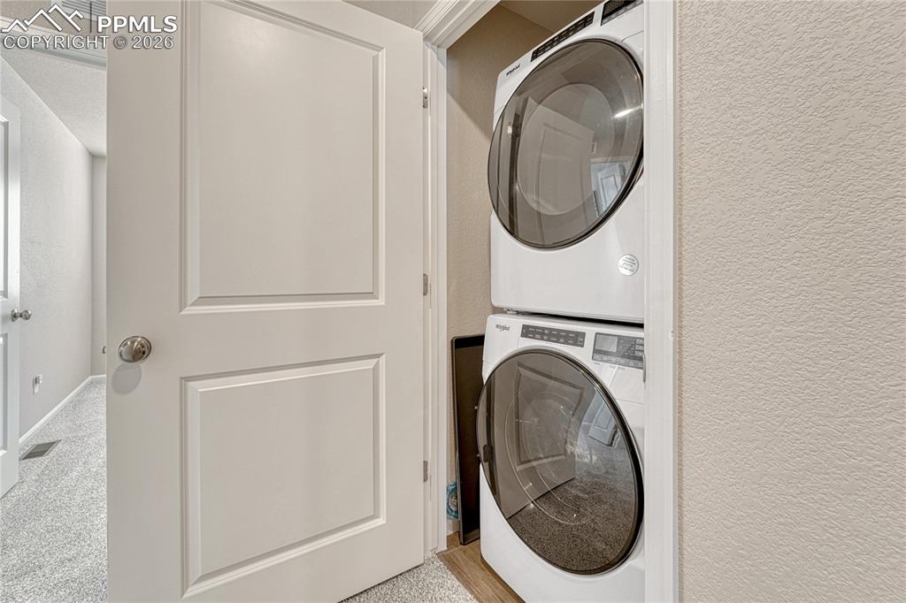 Image 25 of 29: Upstairs laundry space. 