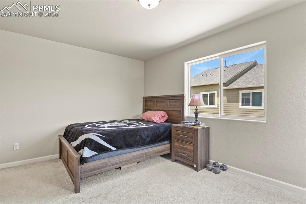 Image 13 of 27: Carpeted bedroom with baseboards