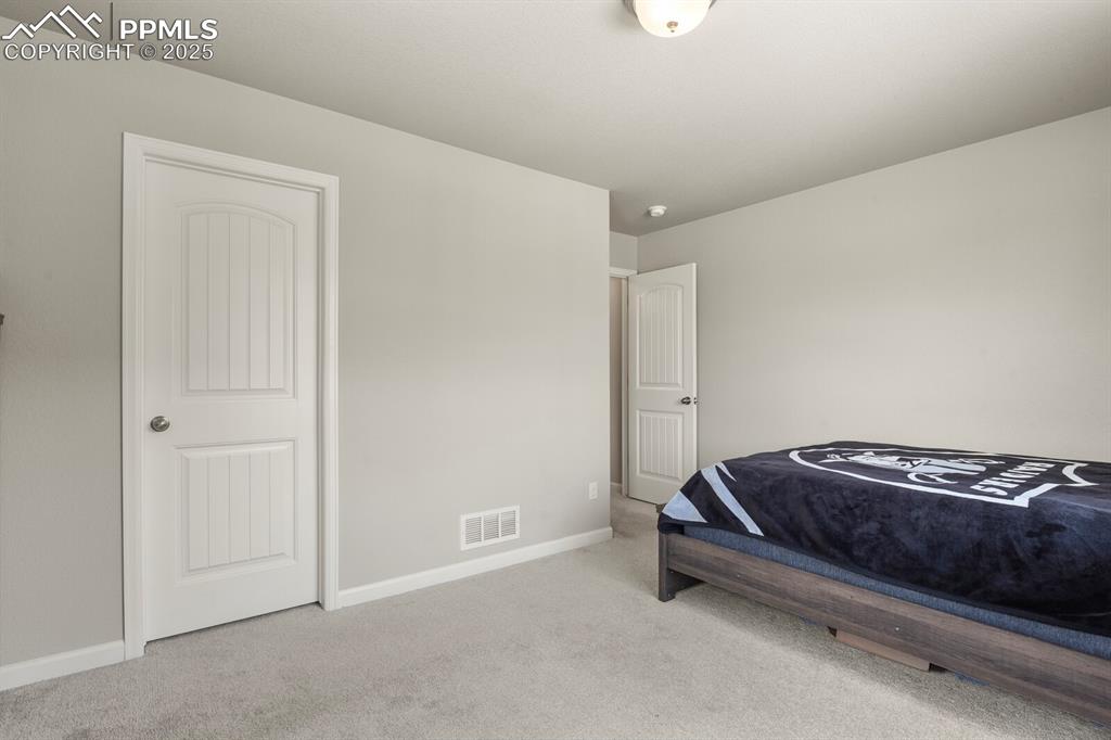 Image 14 of 27: Carpeted bedroom featuring baseboards