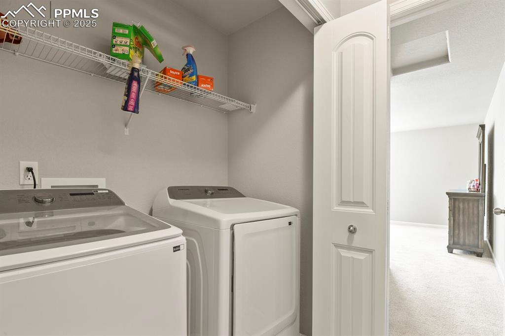 Image 17 of 27: Washroom featuring independent washer and dryer and carpet
