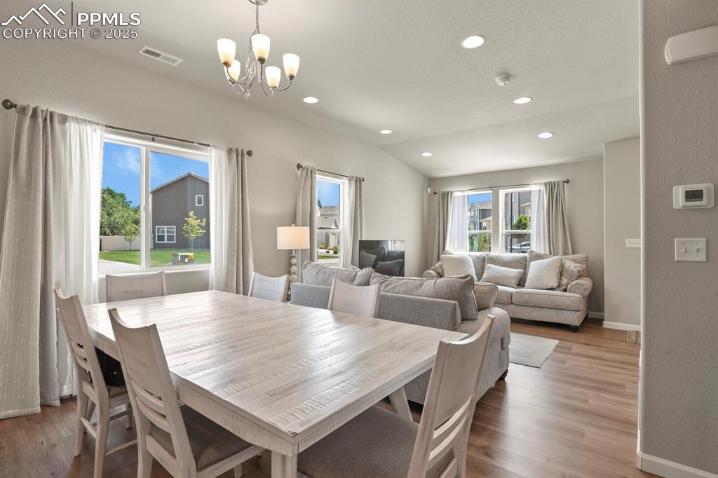 Image 7 of 27: Dining room featuring a chandelier, wood finished floors, and recessed ligh