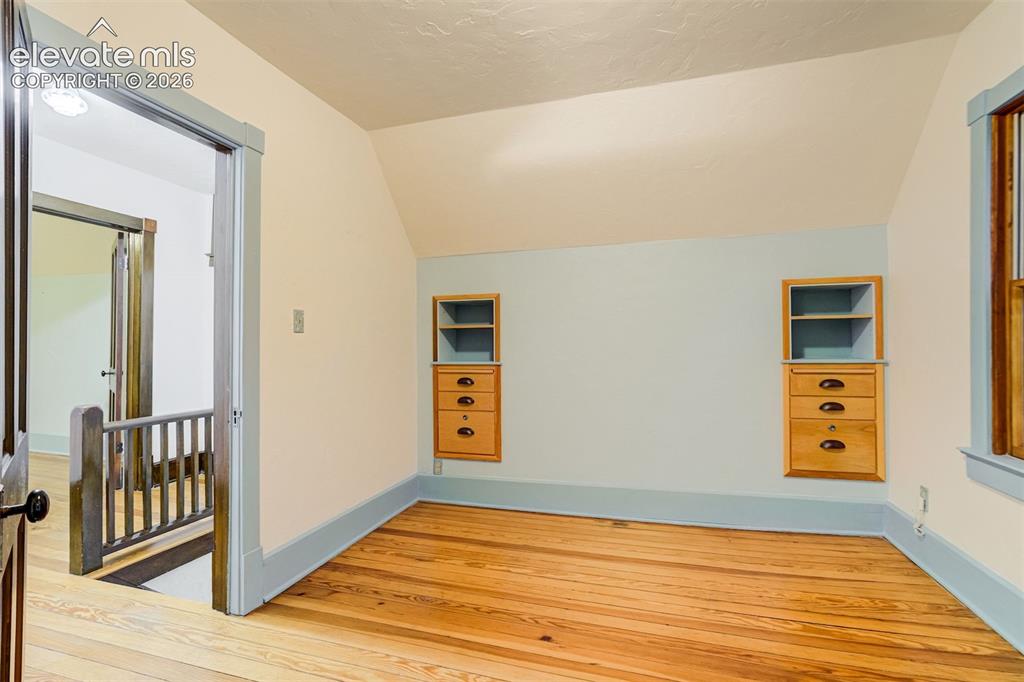 Image 22 of 40: One of 2 upper level bedrooms with built in storage!