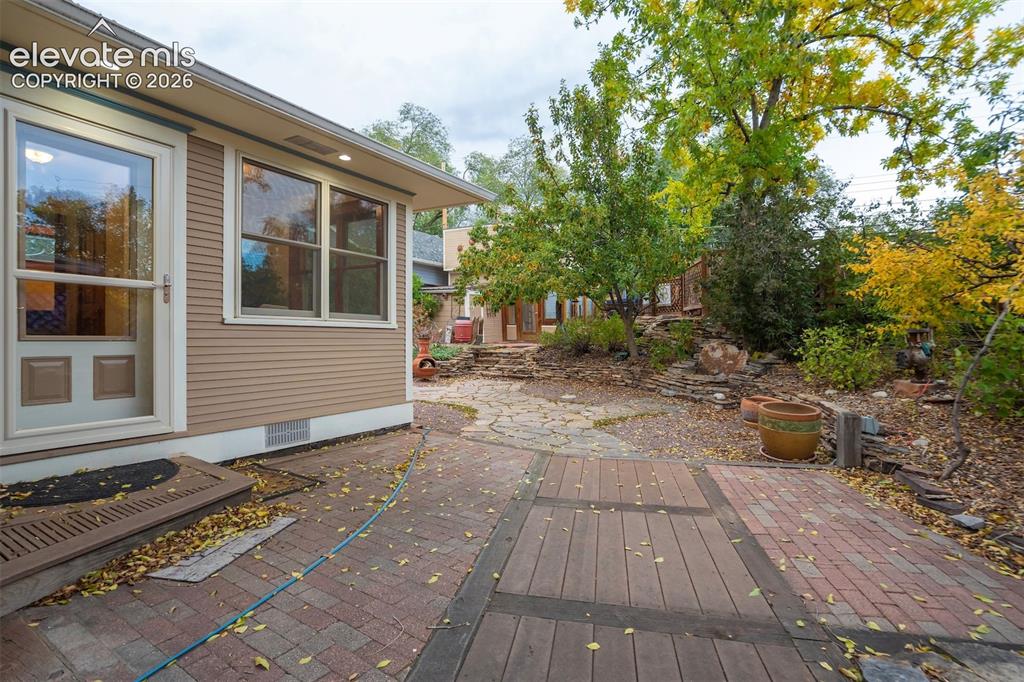 Image 33 of 40: Siding exterior with multiple windows, recessed lighting, and a partially c