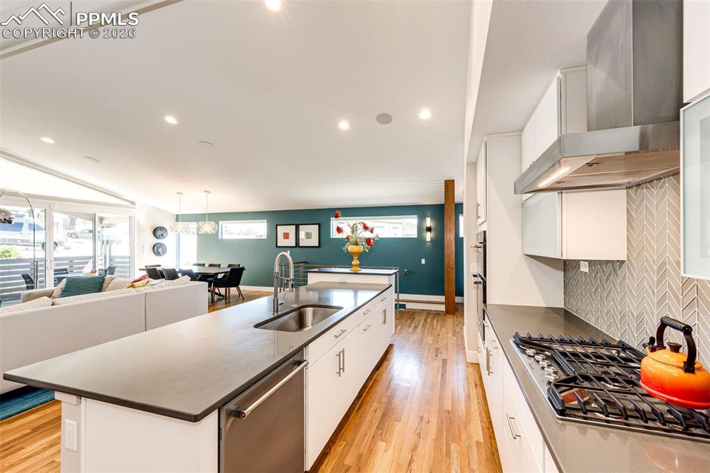 Image 11 of 46: Kitchen Aid Architectural Series appliances with 5 burner gas range and hoo