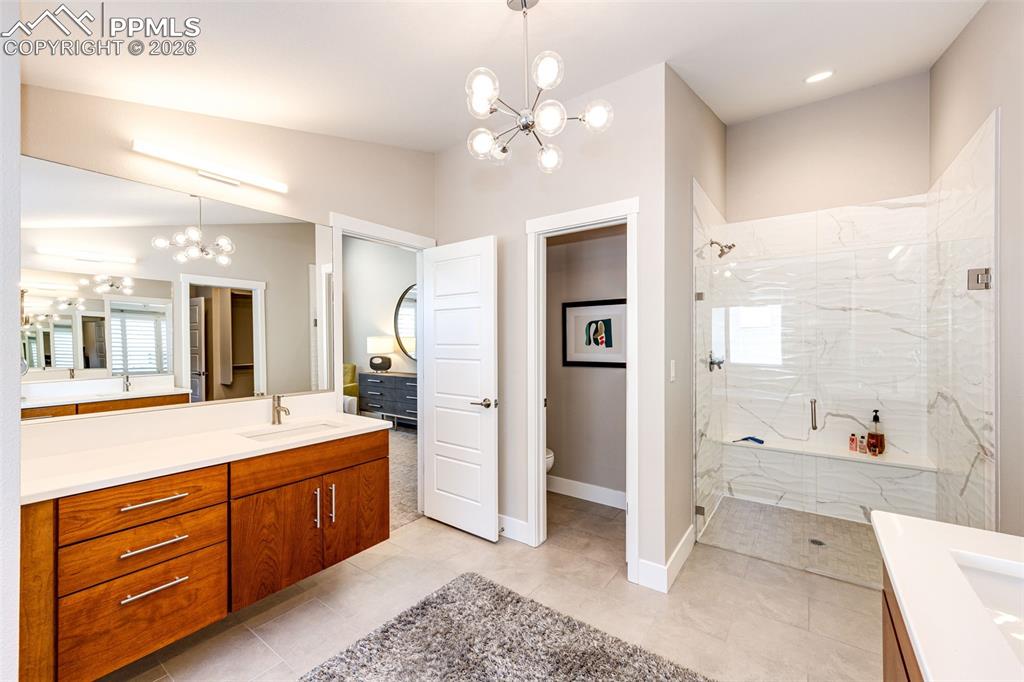 Image 19 of 46: His and Hers sinks and counter area. Custom Resort Style Shower finishes ar