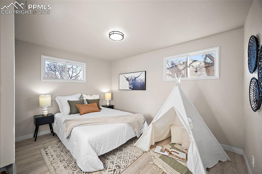 Image 10 of 29: Bedroom featuring baseboards and light wood-type flooring
