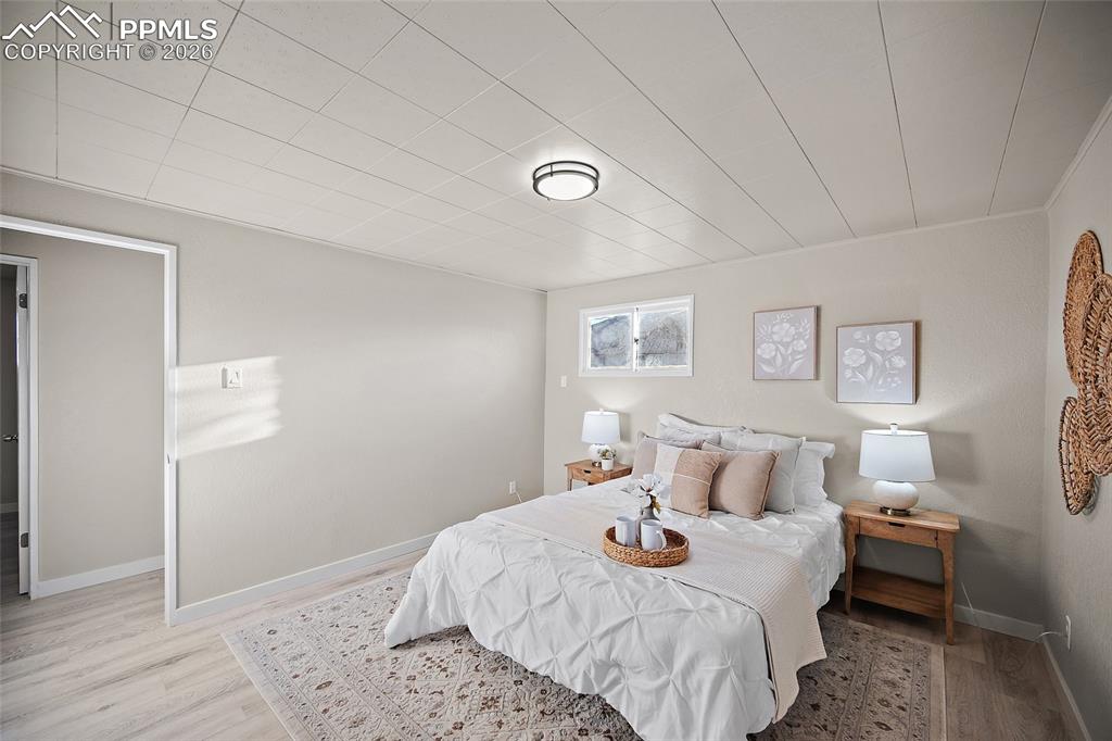 Image 11 of 29: Bedroom with wood finished floors and baseboards