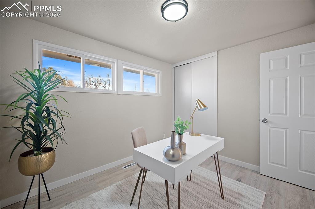 Image 13 of 29: Home office with light wood-style floors and baseboards