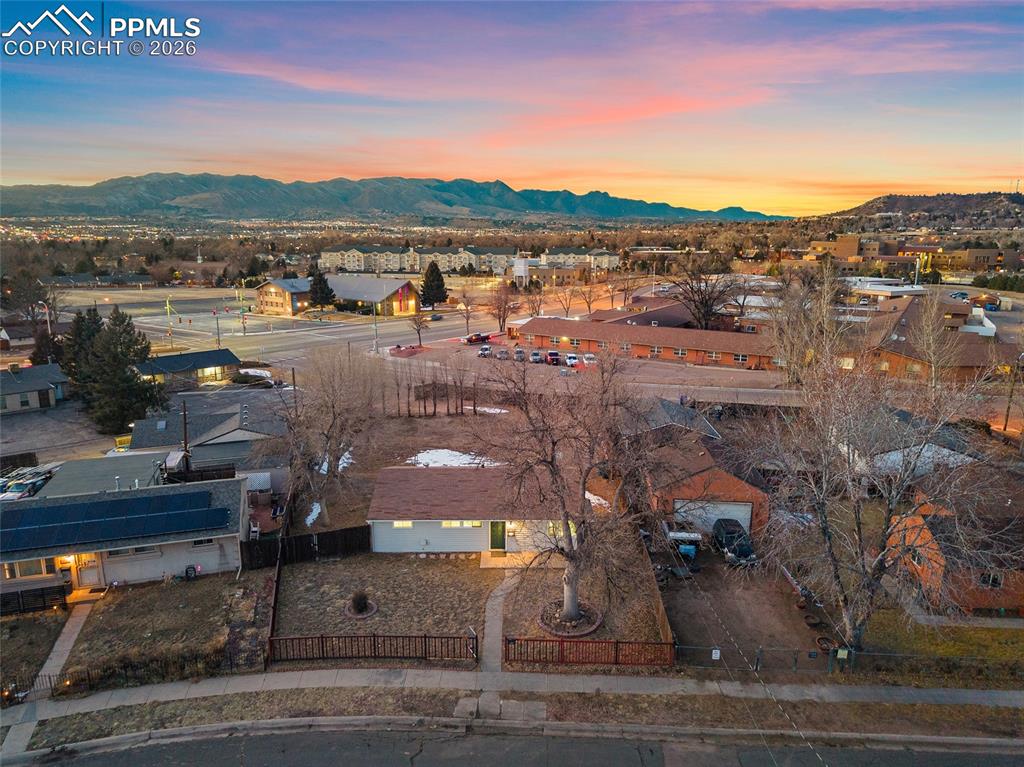 Image 26 of 29: Aerial view at dusk of a mountain view and a residential view