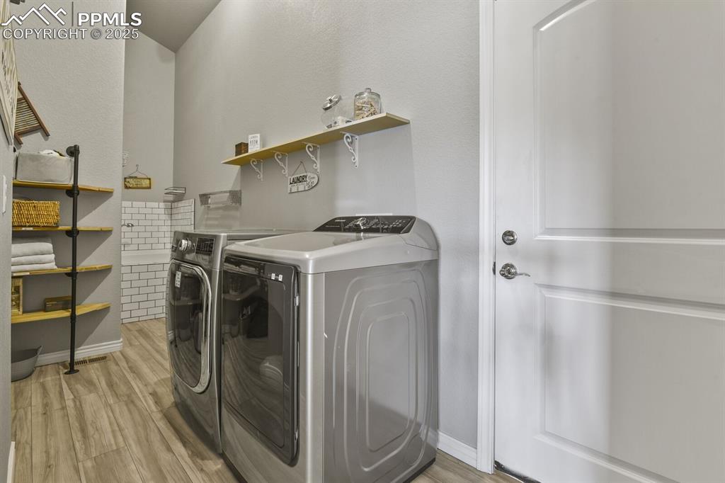 Image 23 of 49: Laundry room with DOGWASH and shelving