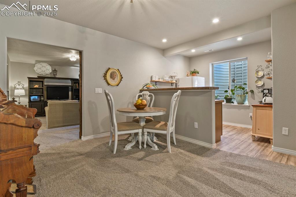 Image 26 of 49: Basement kitchen and dining area, barn doors to the left for privacy