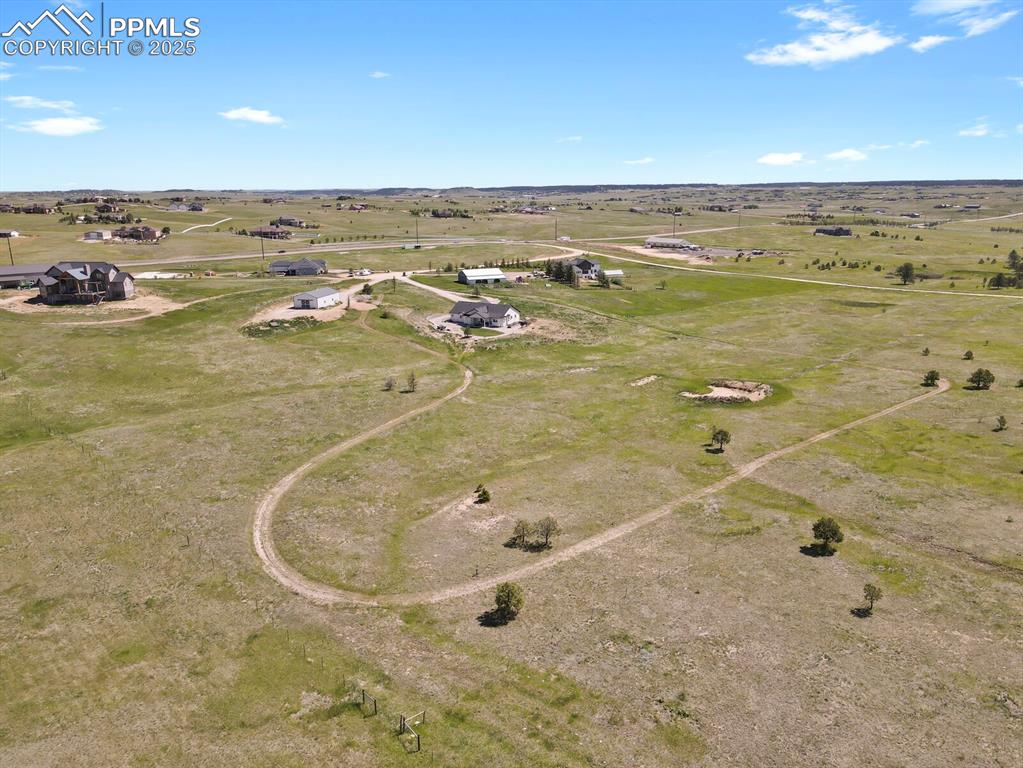 Image 35 of 49: Aerial view with trail on extra lot available for purchase separately. Live