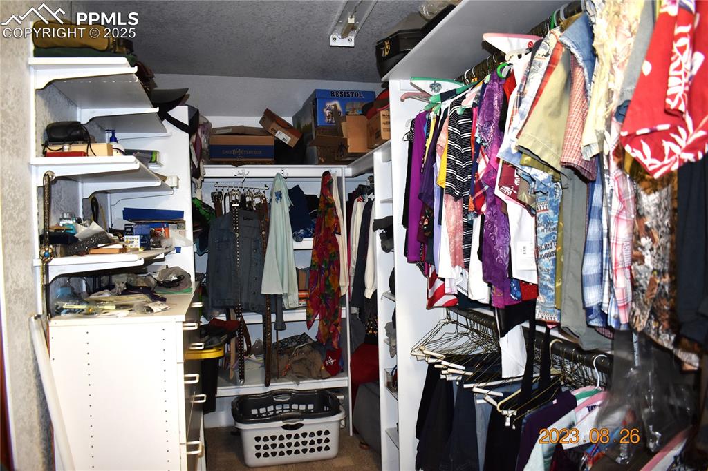 Image 17 of 48: Large walk in closet.  Plenty of room for the shoe lovers and/or clothes fa