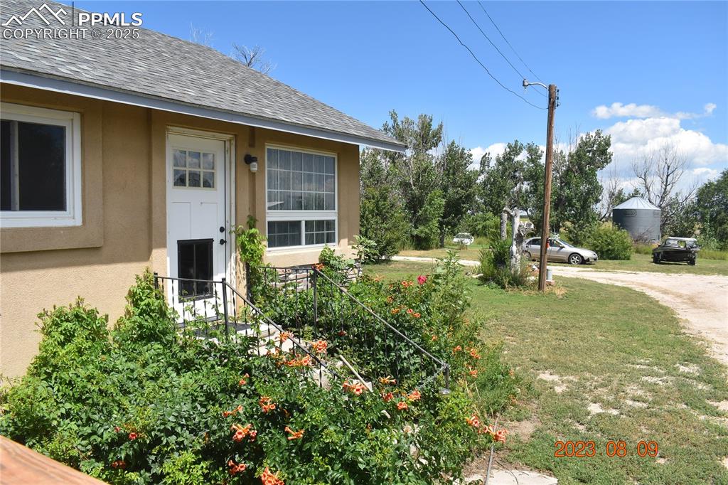 Image 2 of 48: South side of home, This door has a large dog door, it can be replaced with