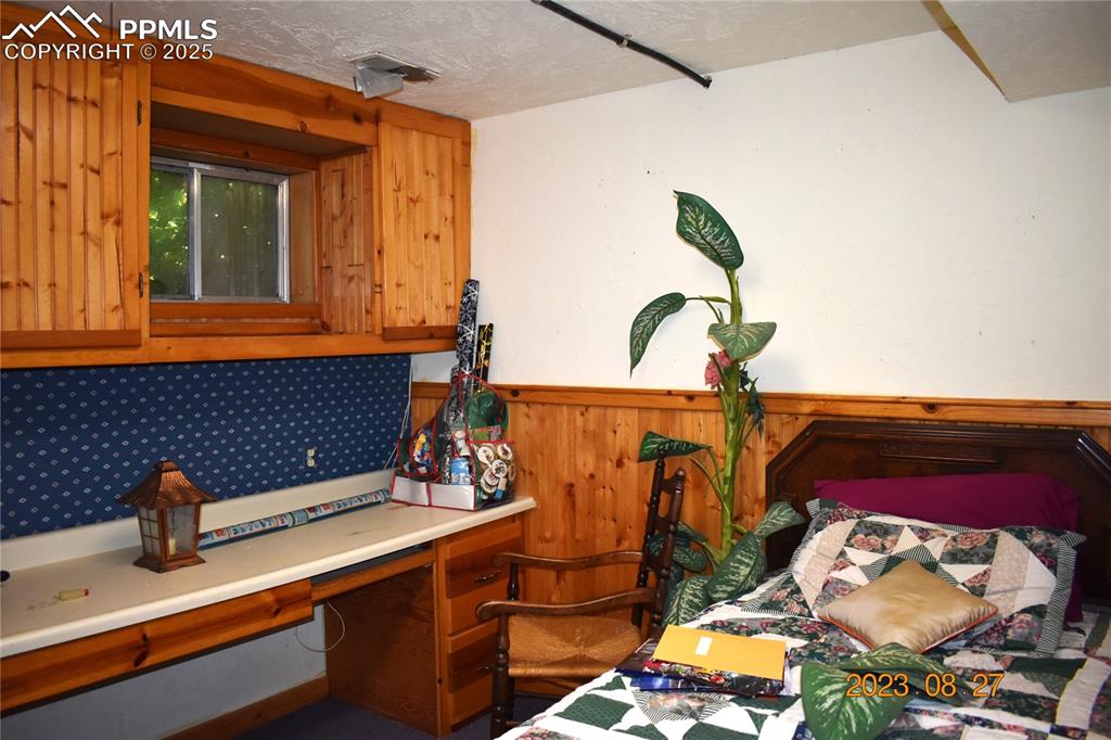 Image 28 of 48: Unconventional bedroom with cabinets and countertops.  often used as a craf