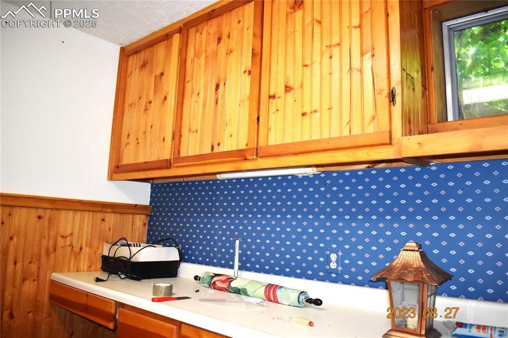 Image 29 of 48: Unconventional bedroom with cabinets, often used as a craft room.  
