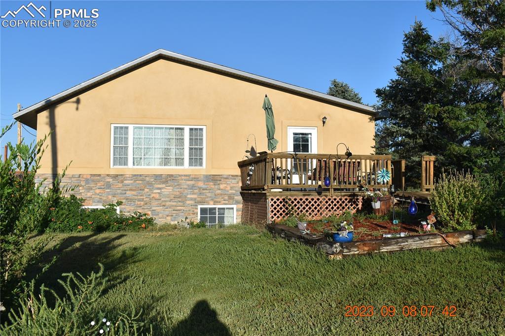 Image 3 of 48: East side of home, has a couple of gardens, a ramp for easy access, and med