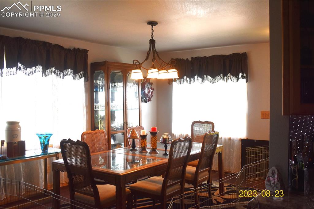 Image 6 of 48: Dining space with a beautiful Chandelier and healthy dose of sunshine.