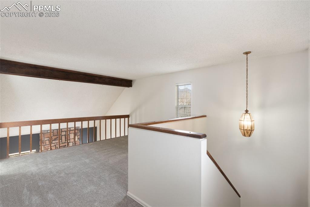 Image 19 of 47: Carpeted loft overlooking the living room