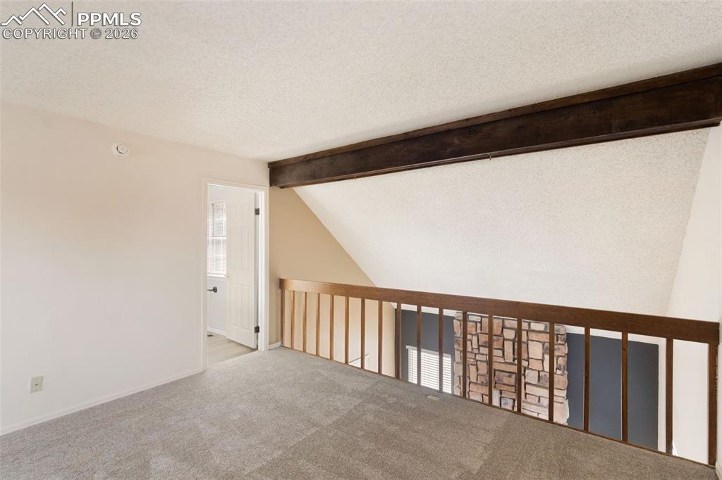 Image 20 of 47: Carpeted loft overlooking the living room