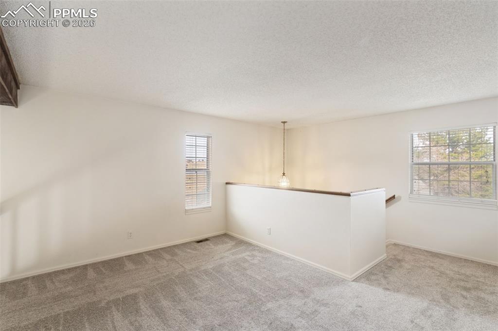 Image 21 of 47: Carpeted loft overlooking the living room