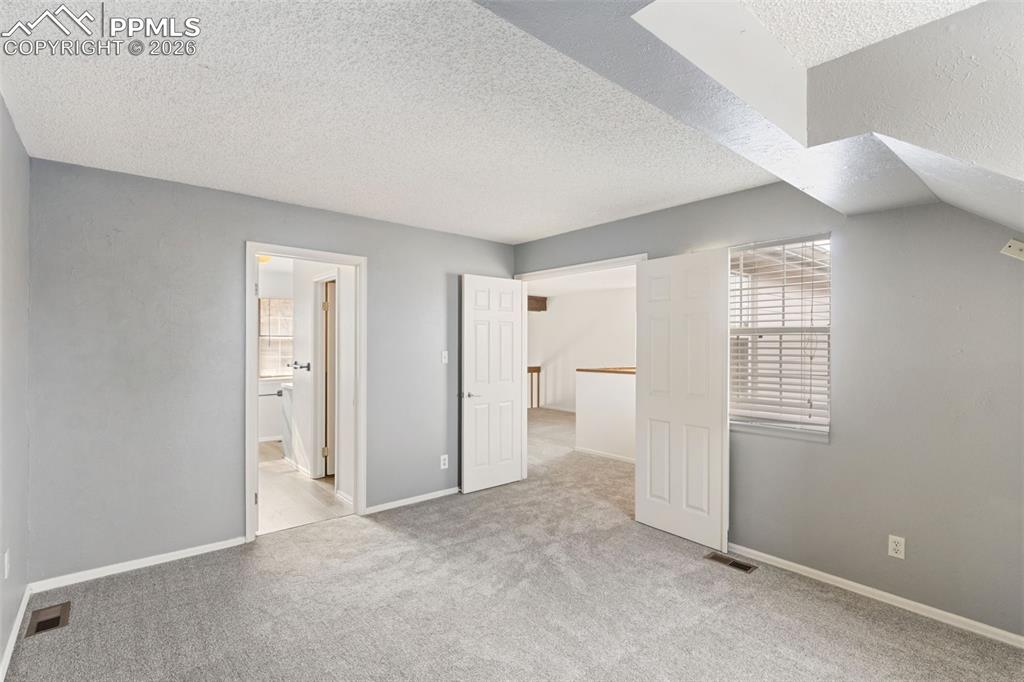 Image 24 of 47: Primary Bedroom with adjoining bathroom and walk-in closet