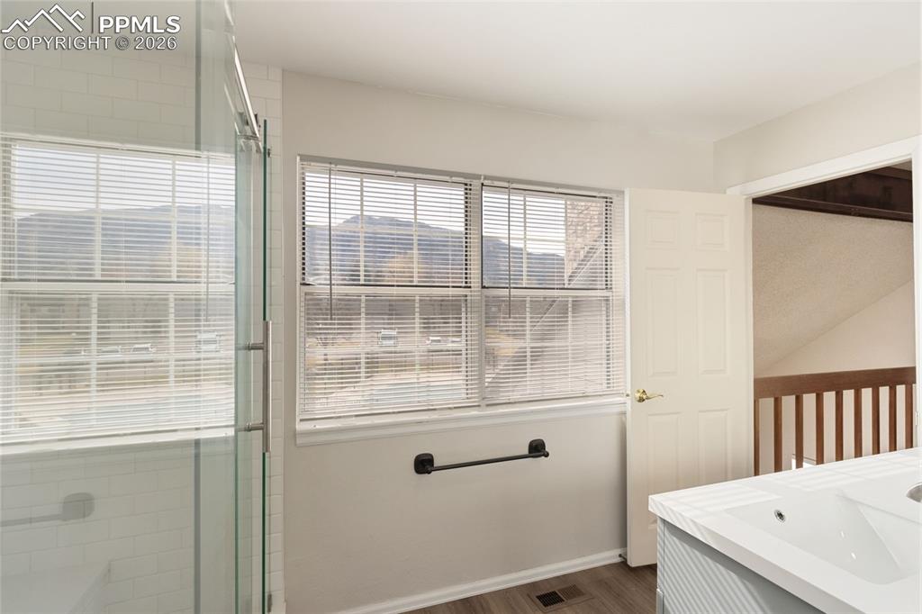 Image 27 of 47: Bathroom featuring double vanity and free-standing shower with barn door