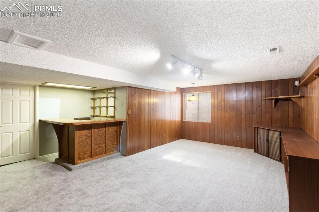 Image 37 of 47: Finished basement, a dry bar (perfect for entertaining)