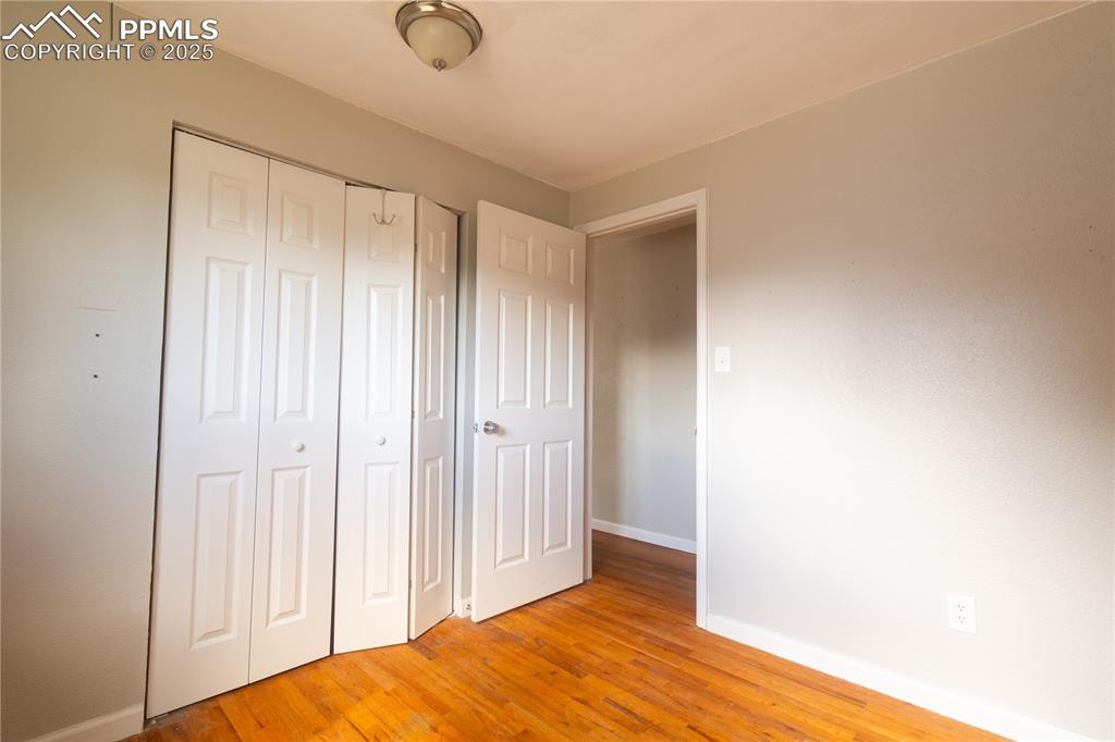 Image 13 of 44: Unfurnished bedroom with light wood-style flooring and a closet