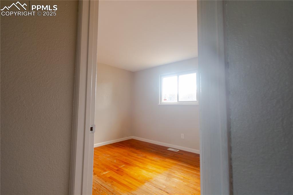 Image 15 of 44: Empty room featuring light wood finished floors and baseboards