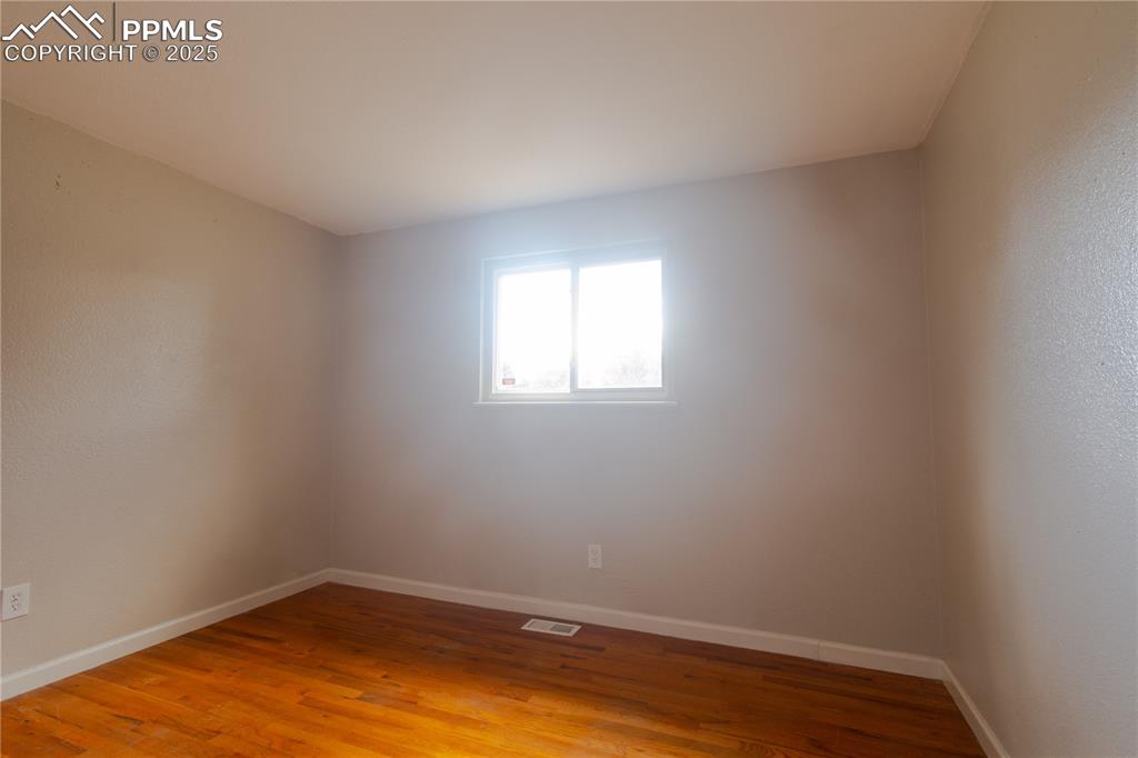 Image 16 of 44: Empty room with light wood finished floors