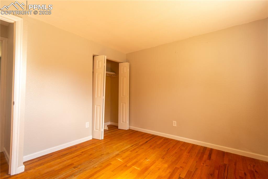 Image 17 of 44: Unfurnished bedroom featuring light wood finished floors and a closet