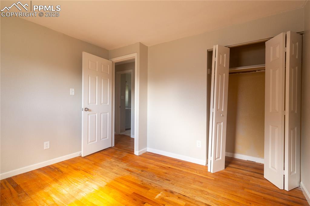 Image 18 of 44: Unfurnished bedroom with light wood finished floors and a closet
