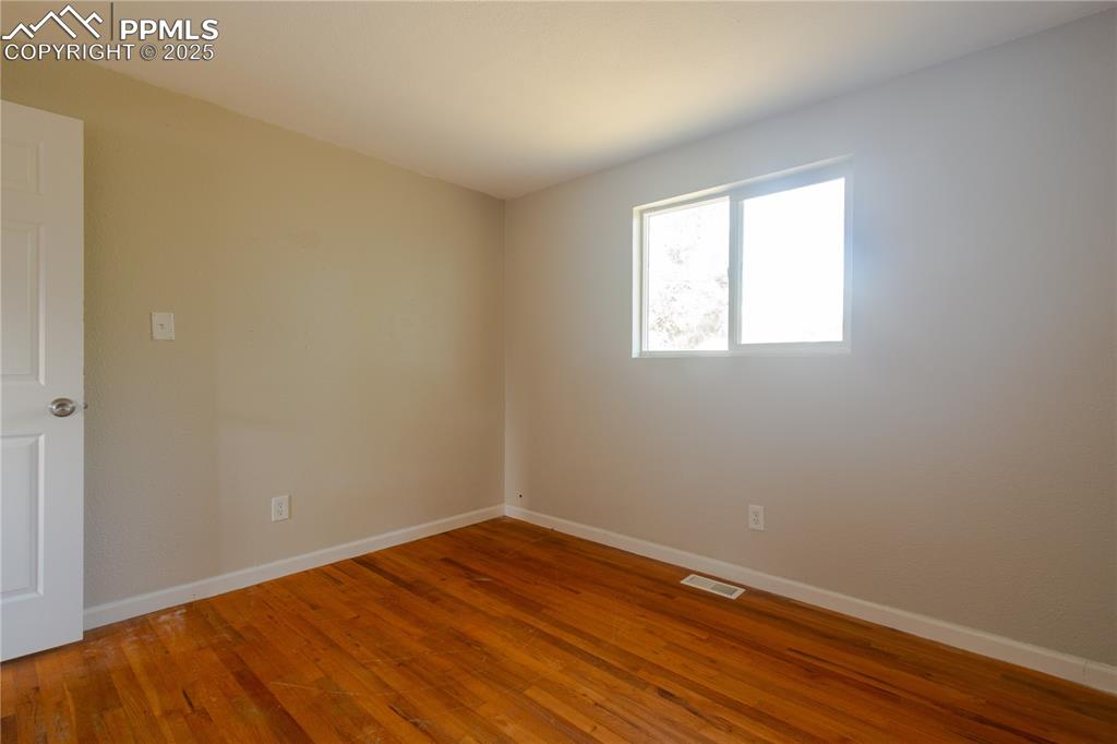 Image 20 of 44: Spare room with wood finished floors