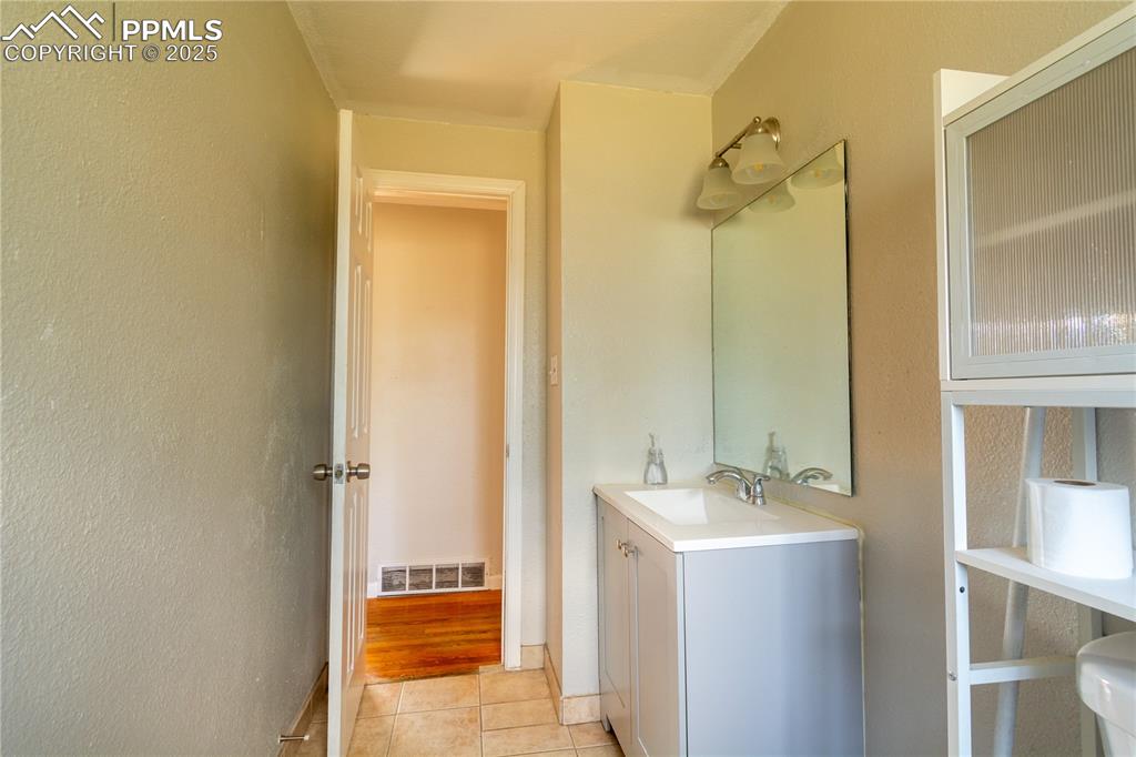 Image 25 of 44: Bathroom featuring vanity and tile patterned flooring