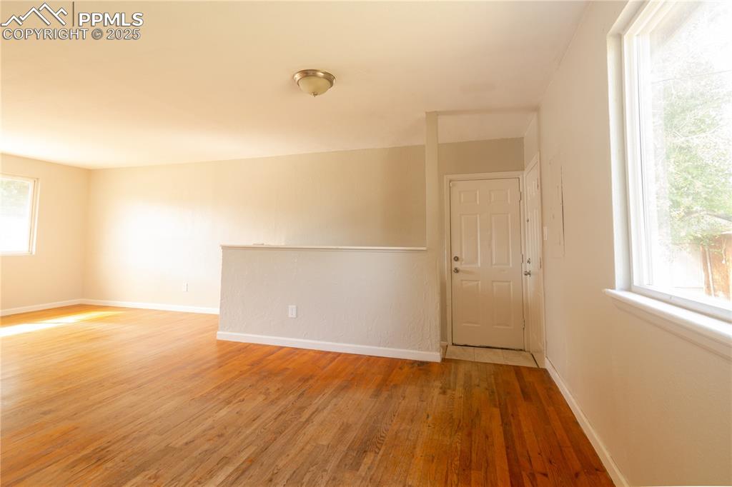 Image 26 of 44: Empty room featuring light wood-type flooring and plenty of natural light