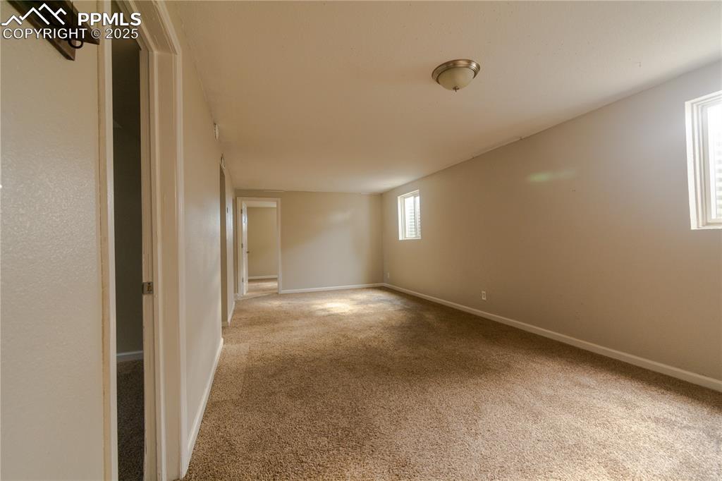 Image 30 of 44: Carpeted empty room featuring baseboards