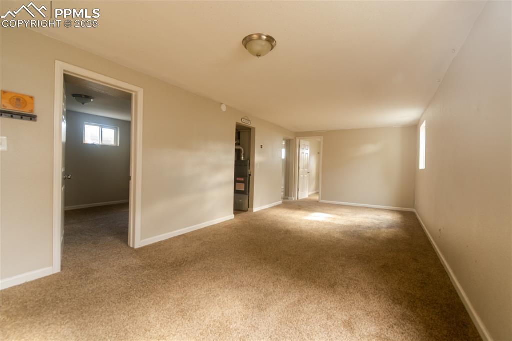 Image 31 of 44: Empty room with carpet flooring and baseboards