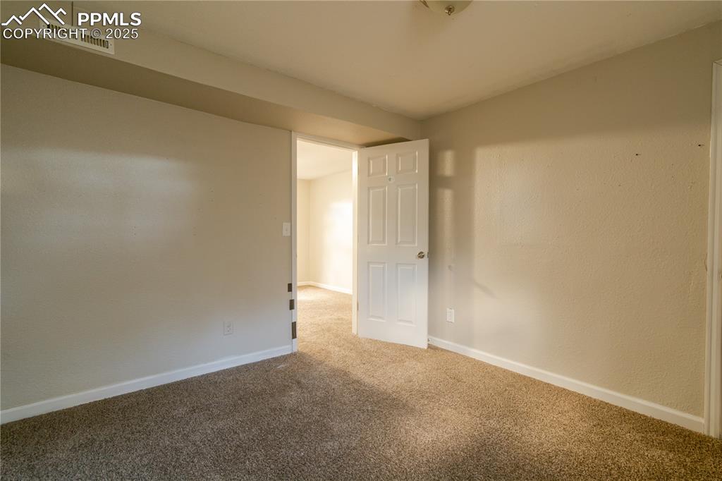 Image 34 of 44: Carpeted empty room with baseboards