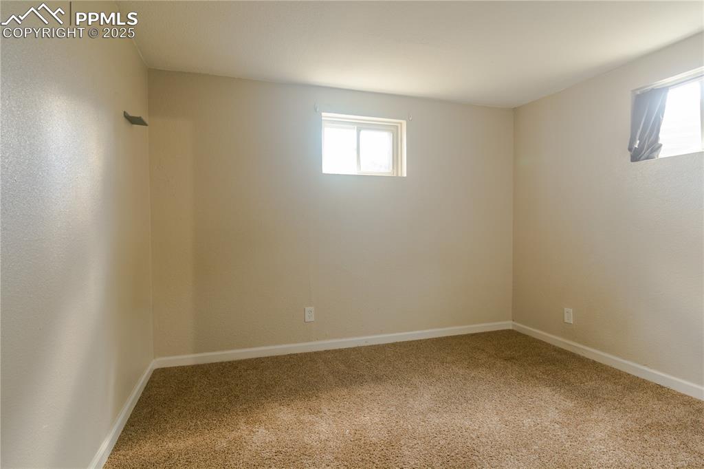 Image 35 of 44: Unfurnished room featuring plenty of natural light and carpet flooring
