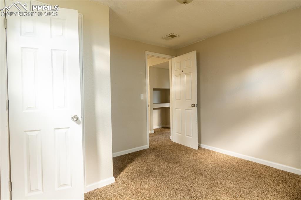 Image 36 of 44: Unfurnished bedroom with carpet and baseboards