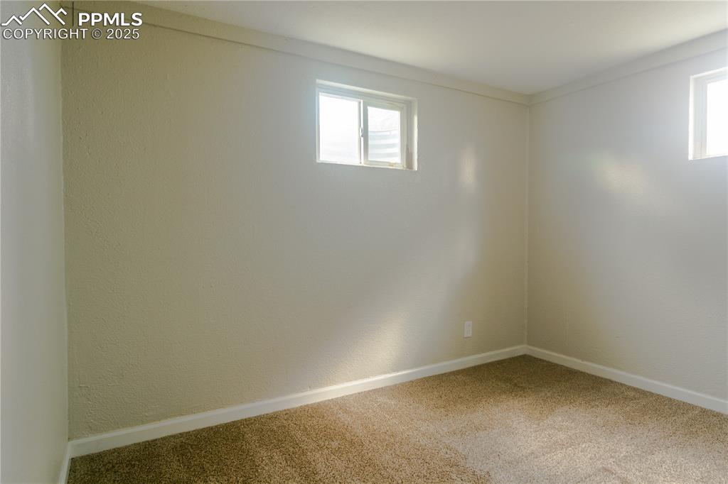 Image 37 of 44: Unfurnished room featuring healthy amount of natural light and carpet