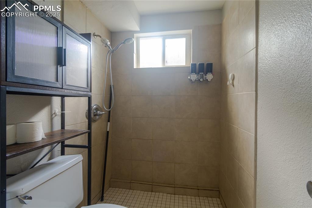 Image 40 of 44: Full bathroom with toilet and tiled shower