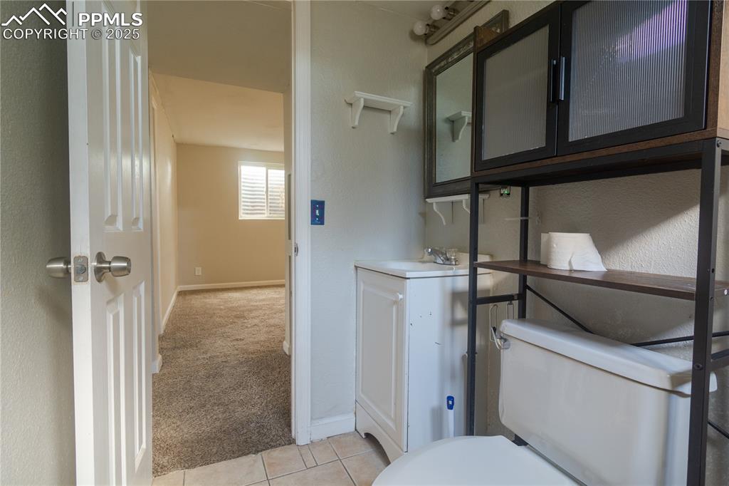Image 41 of 44: Half bath with vanity and tile patterned floors