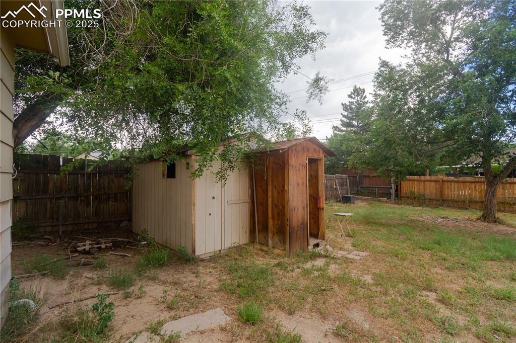 Image 44 of 44: Fenced backyard featuring a shed