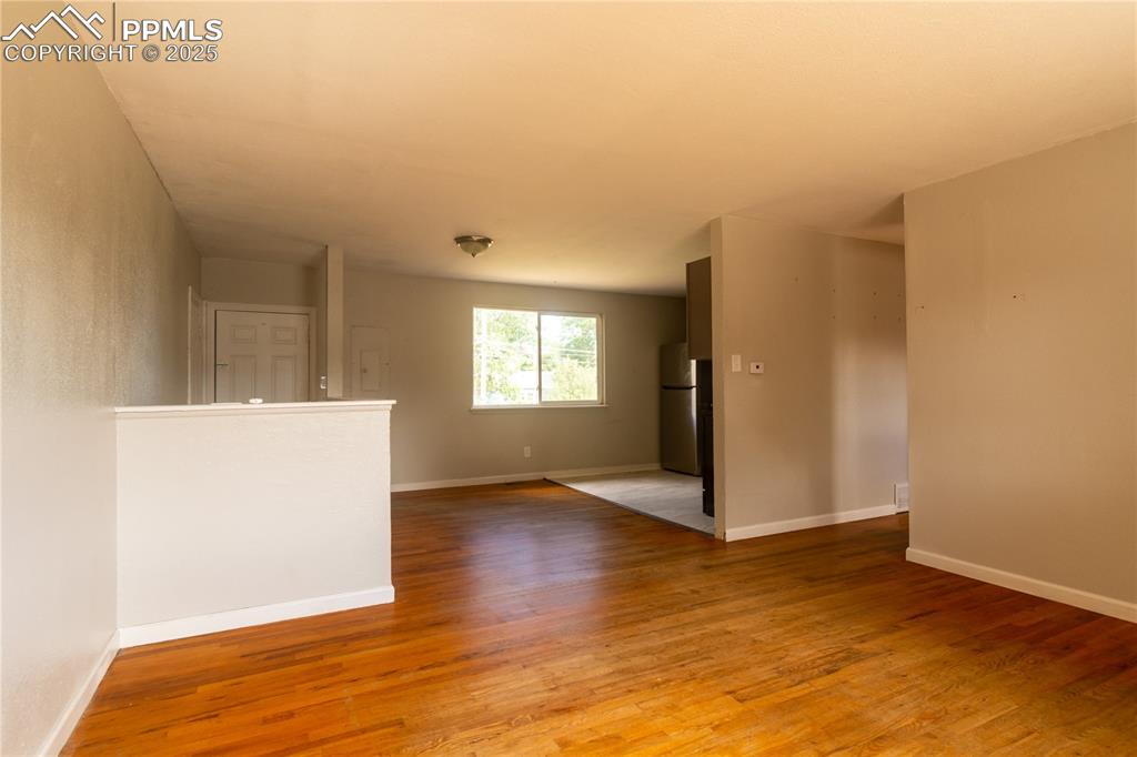 Image 6 of 44: Spare room with light wood-type flooring and baseboards