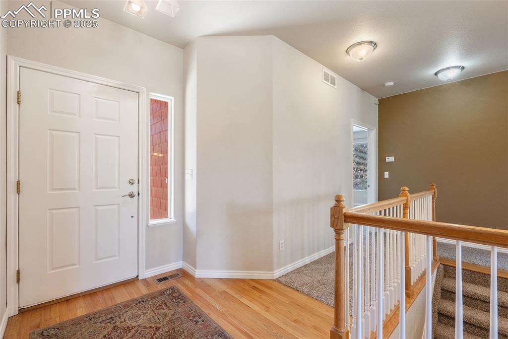 Image 21 of 50: Entryway featuring wood finished floors and baseboards
