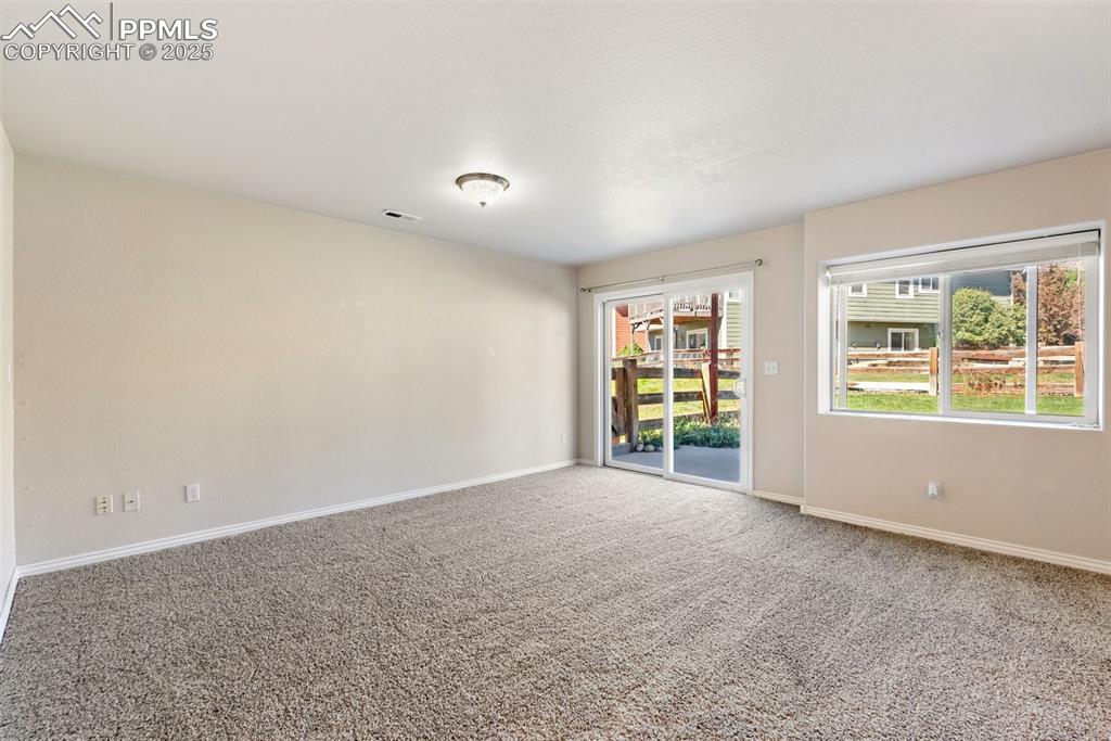 Image 26 of 50: Carpeted empty room with baseboards