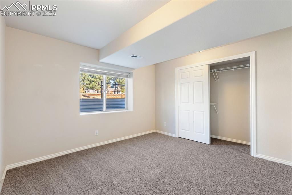 Image 33 of 50: Unfurnished bedroom with carpet and a closet